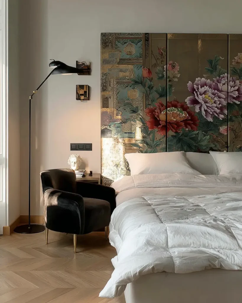 49 Headboard Design Ideas That Instantly Elevate Your Bedroom 14 Large floral Chinoiserie folding screen used as a headboard with gold accents and modern floor lamp.