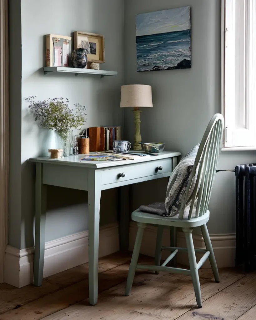 Quiet study corner with soft, grey-green walls and a matching pale blue-green desk and chair.