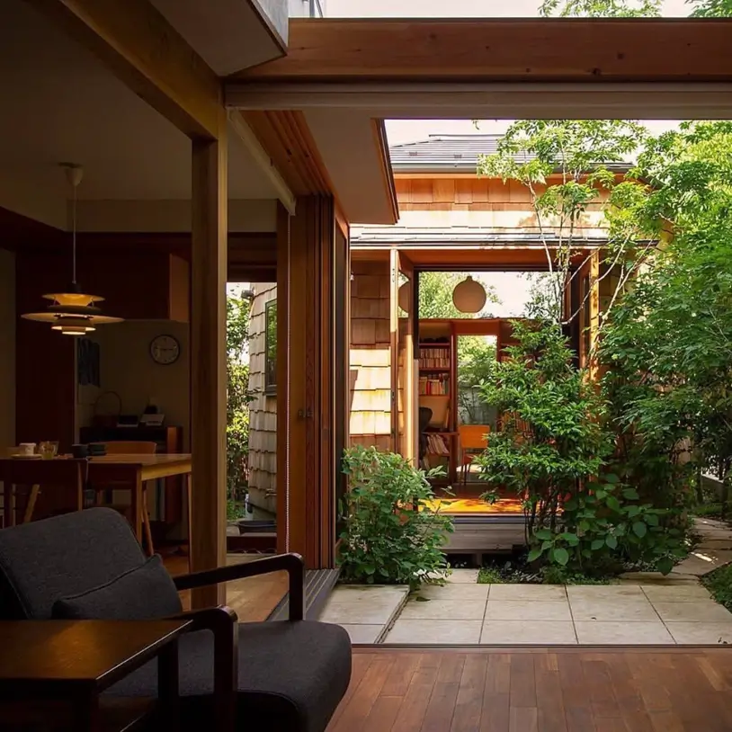 A modern Japanese home interior looking across a central garden courtyard to another wing.