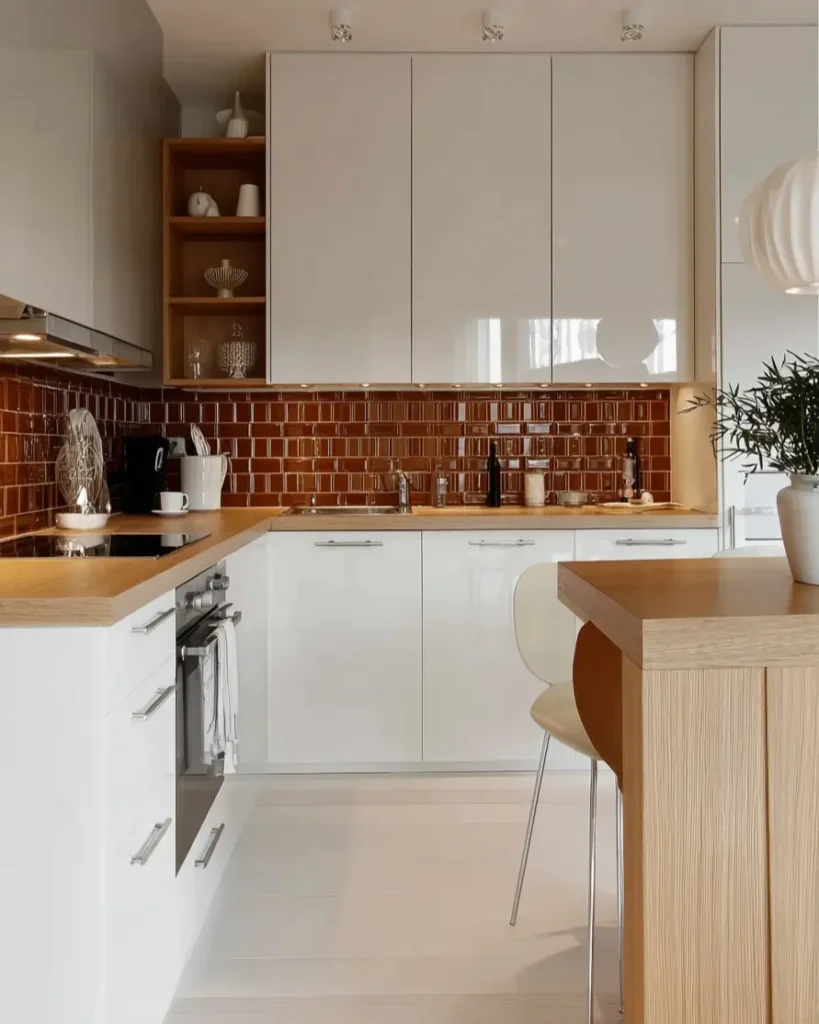 Scandinavian kitchen ideas featuring glossy amber tile backsplash and butcher block counters.