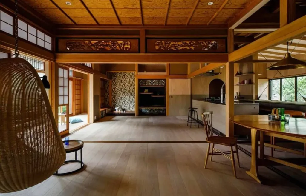 A Japanese home interior with ornate carved wooden transoms (ramma) and a coffered ceiling.