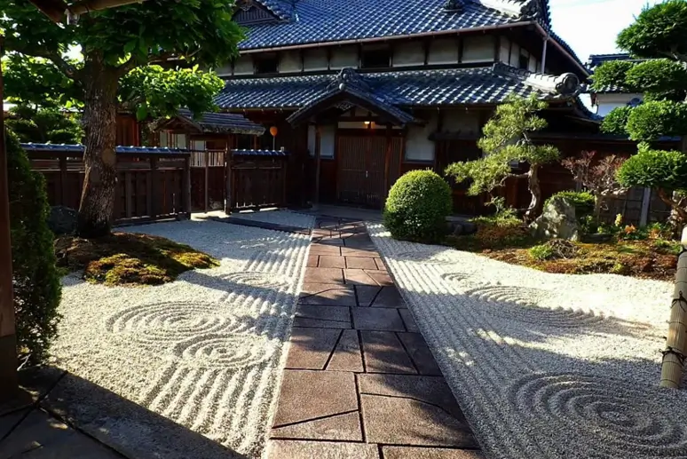 Japanese zen garden entryway with a stone path and raked gravel in circular patterns.