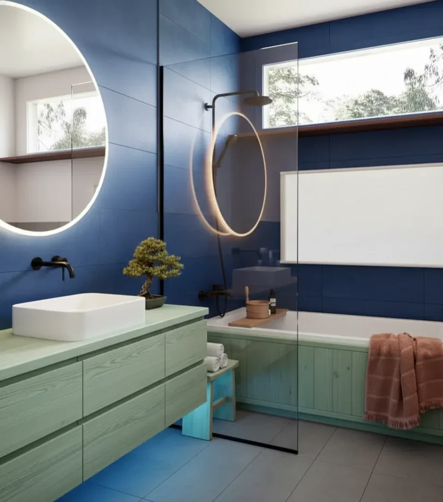 26 Japanese Bathroom Design Ideas for a Serene Home Oasis 4 A modern Japanese inspired bathroom with blue tiles, a mint green vanity, a white tub, and a small bonsai tree.