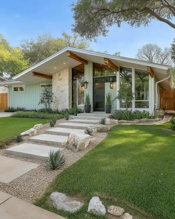 A modern ranch style house with a mid-century angled roof and stone accent wall.