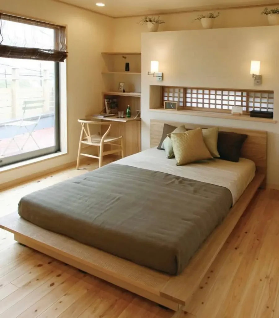 A modern Japanese bedroom with light wood floors, a low platform bed, and a built-in headboard niche with a lattice screen.