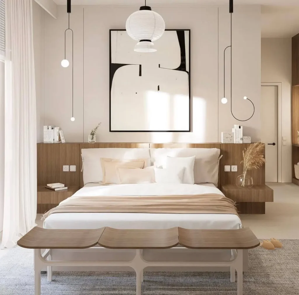 A modern Japandi bedroom by Hevi Studio with a paper lantern, minimalist pendant lights, and a built-in wood headboard with abstract art.
