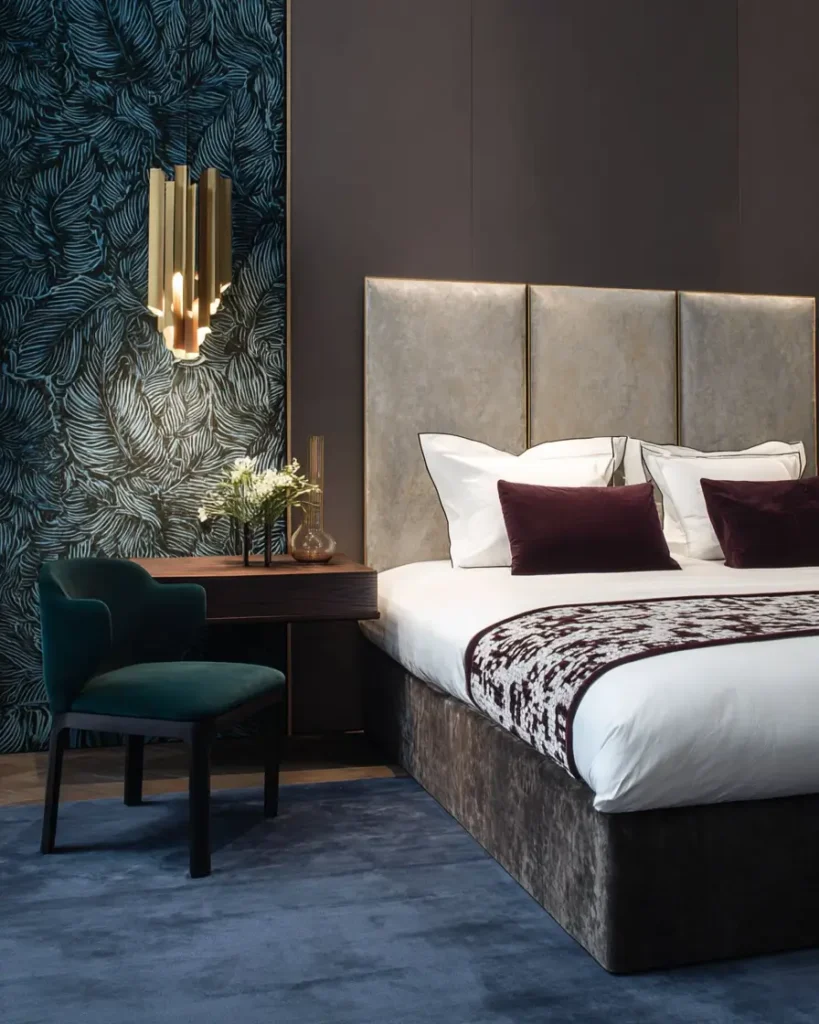 49 Headboard Design Ideas That Instantly Elevate Your Bedroom 26 Grey velvet panel headboard with gold metal trim and emerald green velvet accent chair.