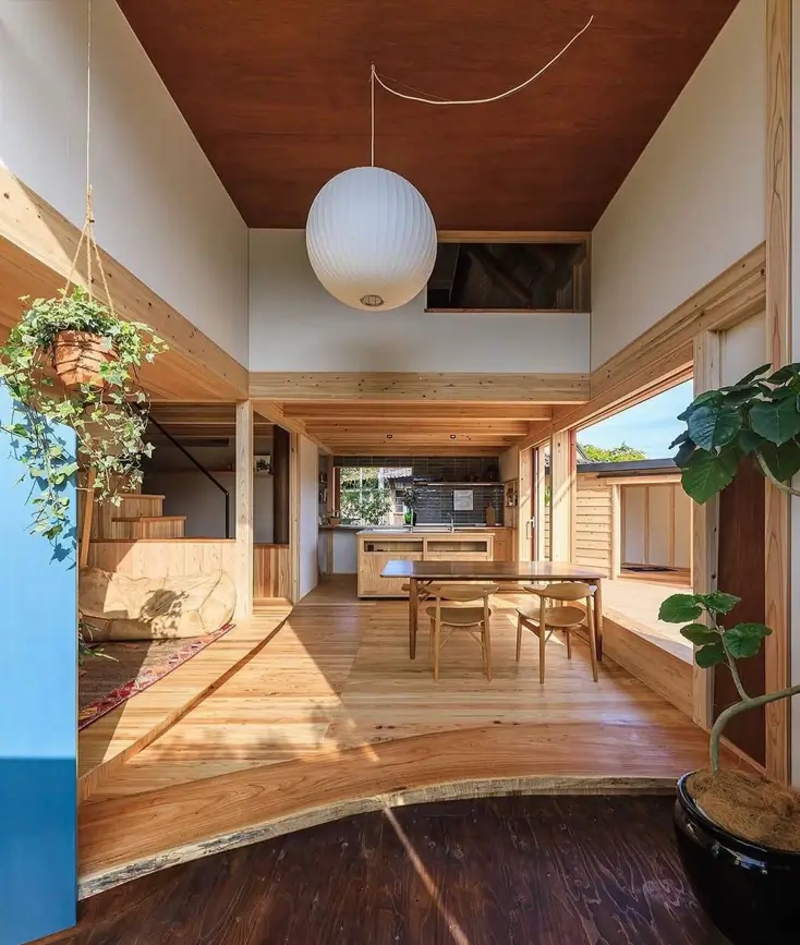 Modern Japanese home interior with a large paper lantern, light wood floors, and an open-plan design.