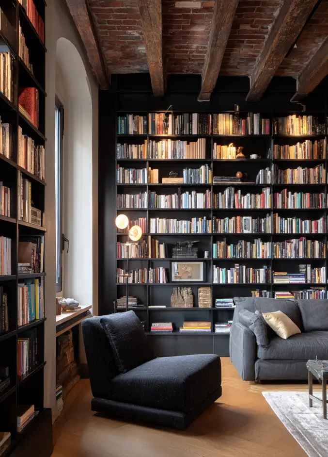 Modern Tudor Interior Design: A Definitive Guide 28 A modern library with a rustic exposed-brick and wood-beam ceiling, contrasted by sleek, black floor-to-ceiling bookshelves.