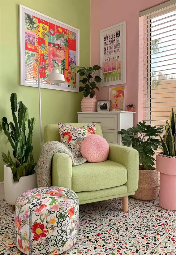 Playful sitting area with a light green armchair, a spring-green wall, and a contrasting pale pink wall.