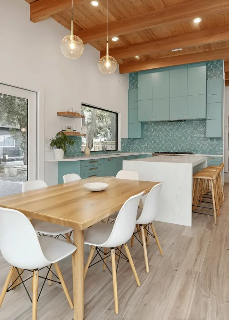 Modern ranch interior design kitchen with teal cabinets and a vaulted wood ceiling.