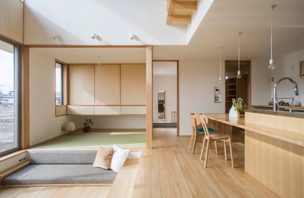 A modern Japan house interior design blending wood floors with a raised tatami mat area and built-in seating.