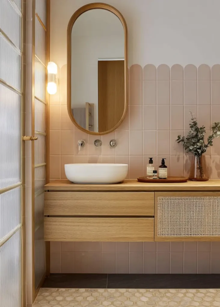 46 Scandinavian Bathroom Design Ideas for a Serene Sanctuary 5 Blush pink tiles with scalloped edges and floating wooden vanity in a Scandinavian bathroom design.