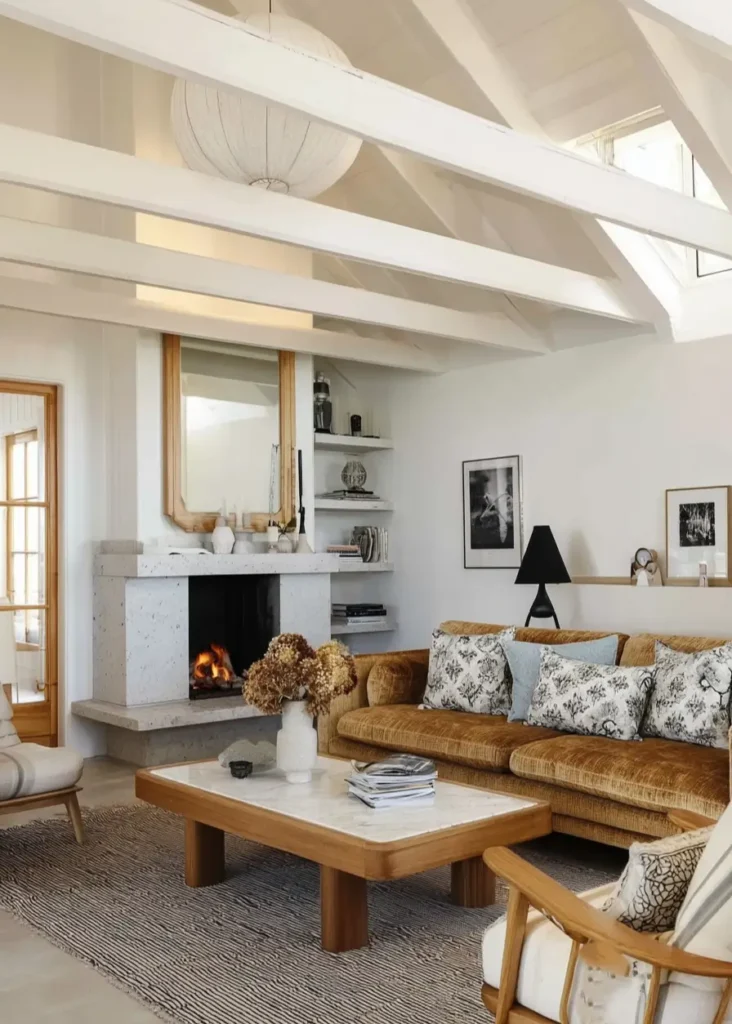 35 Scandinavian Living Room Ideas for a Cozy, Minimalist Home 5 White painted exposed ceiling beams above a velvet sofa in a bright Scandinavian minimalist living room.