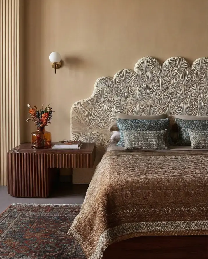 49 Headboard Design Ideas That Instantly Elevate Your Bedroom 32 Beige scalloped plaster relief headboard with fan motifs and dark wood ribbed nightstand.