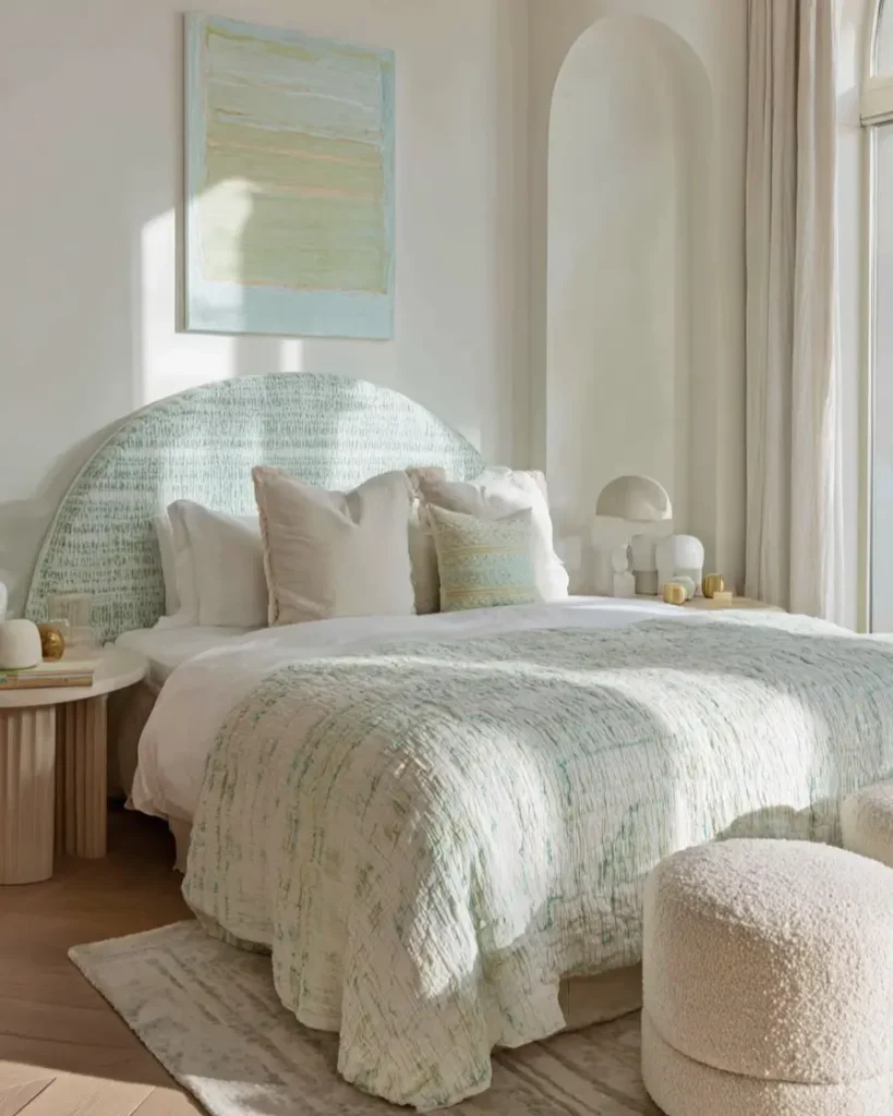 49 Headboard Design Ideas That Instantly Elevate Your Bedroom 35 Mint green bouclé arched headboard with matching bedding and textured cream ottomans.