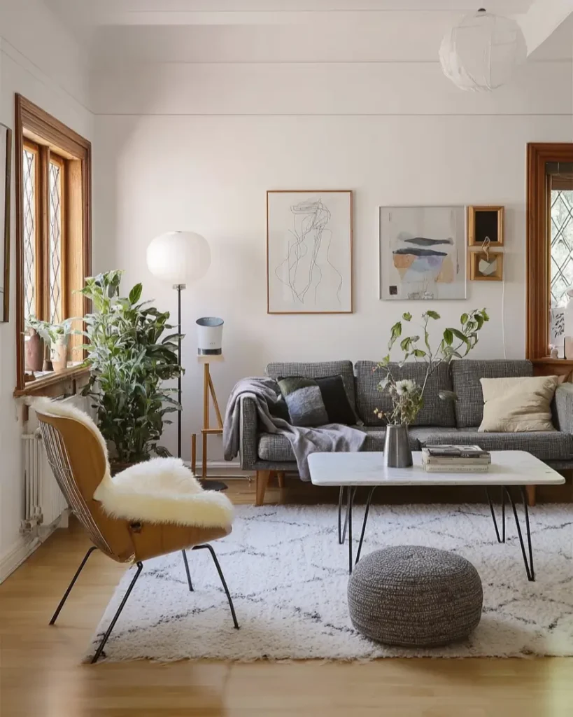 35 Scandinavian Living Room Ideas for a Cozy, Minimalist Home 37 Curated art niches with eclectic framed artwork in a white Scandinavian living room with mid-century modern furniture.