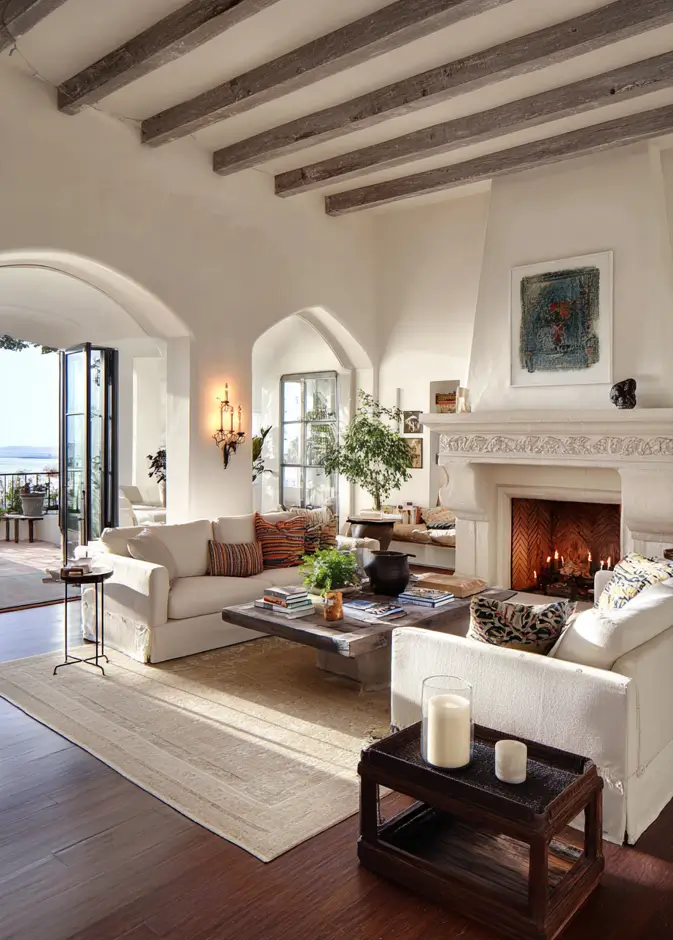 46 Modern Mediterranean Living Room Design Ideas 42 Airy Mediterranean living room with folding glass doors opening to a coastal terrace.