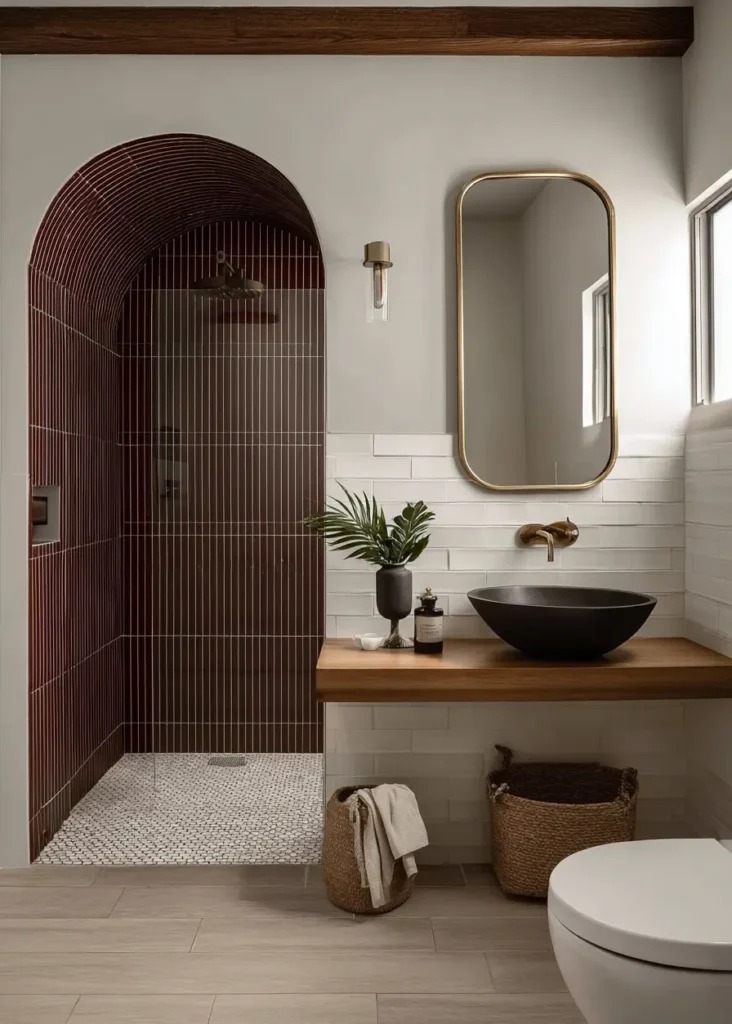 46 Scandinavian Bathroom Design Ideas for a Serene Sanctuary 42 Burgundy tiled arched shower alcove with floating wood vanity and black vessel sink.