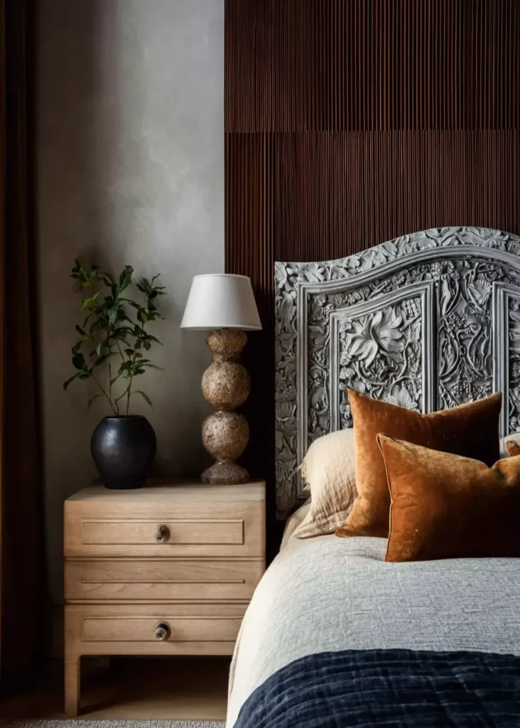 49 Headboard Design Ideas That Instantly Elevate Your Bedroom 45 Grey painted intricately carved floral wood headboard with velvet rust pillows.