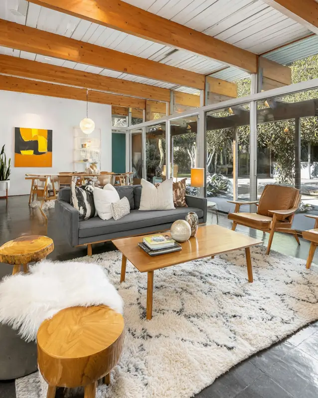 Modern ranch interior design living room with exposed wood beams and mid-century furniture.