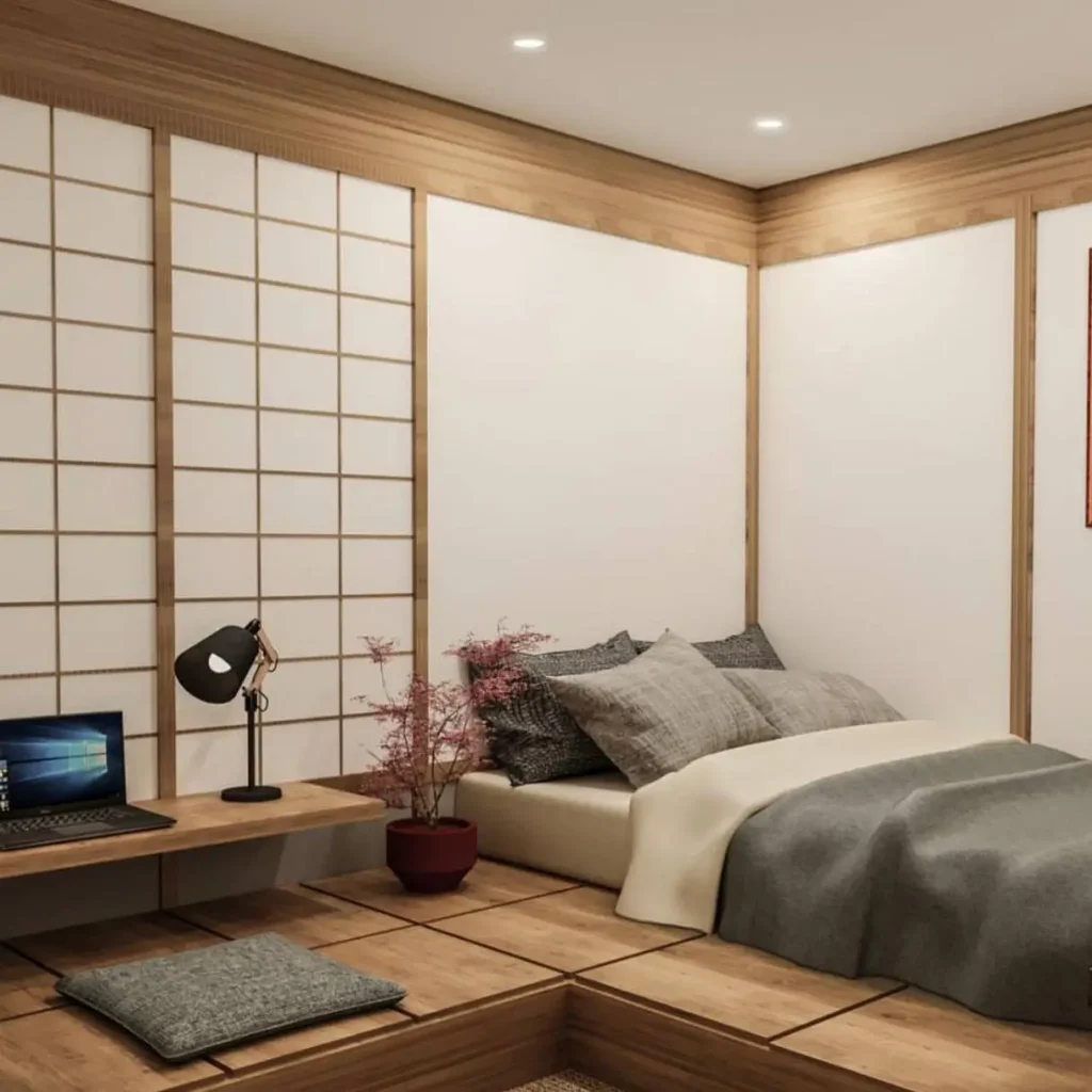 A Japanese-style bedroom with a raised wooden platform for the bed and a lower level with a desk and floor cushion.