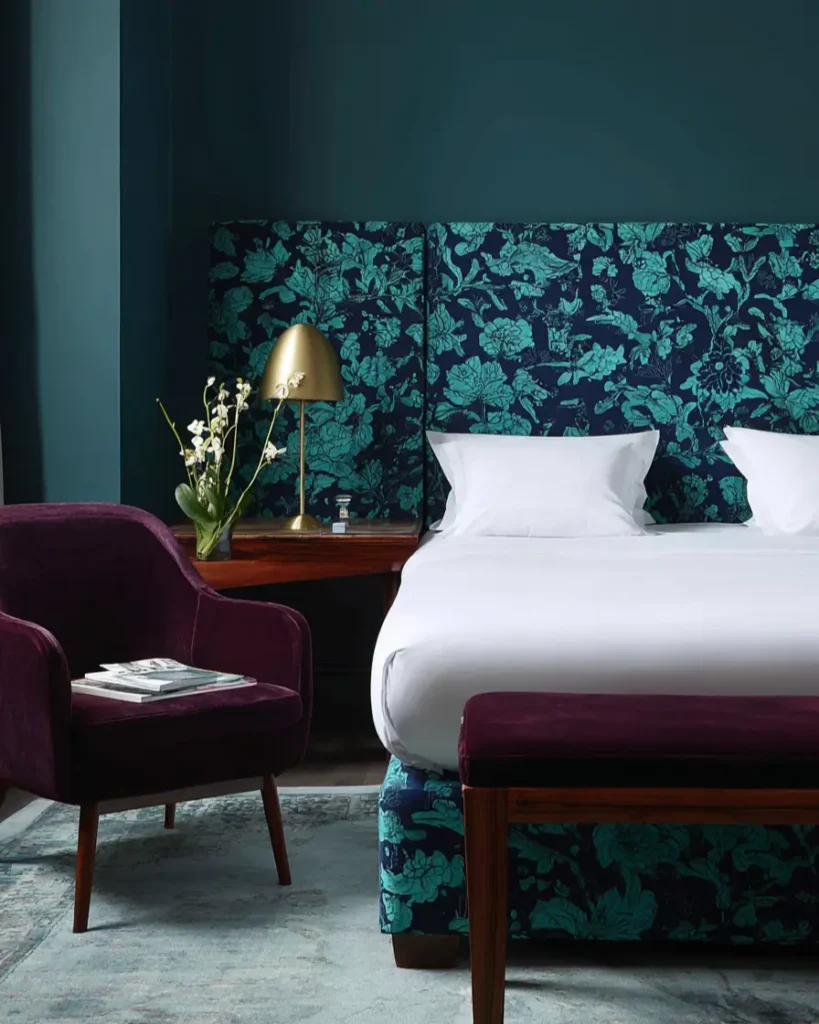 49 Headboard Design Ideas That Instantly Elevate Your Bedroom 9 Teal and navy floral upholstered headboard and bed frame with deep purple accent furniture.