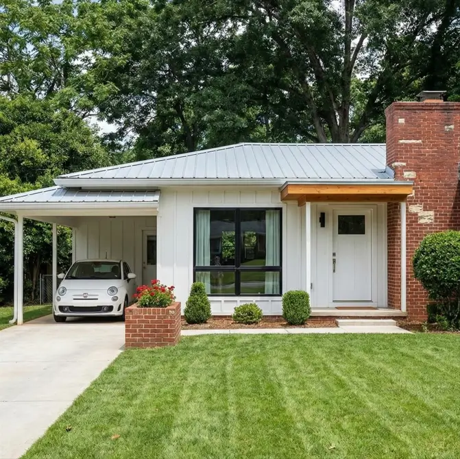 26 Small Ranch-Style House Ideas for Timeless Modern Living 3 A white small Ranch-style house featuring a standing seam metal roof and brick chimney for modern curb appeal.
