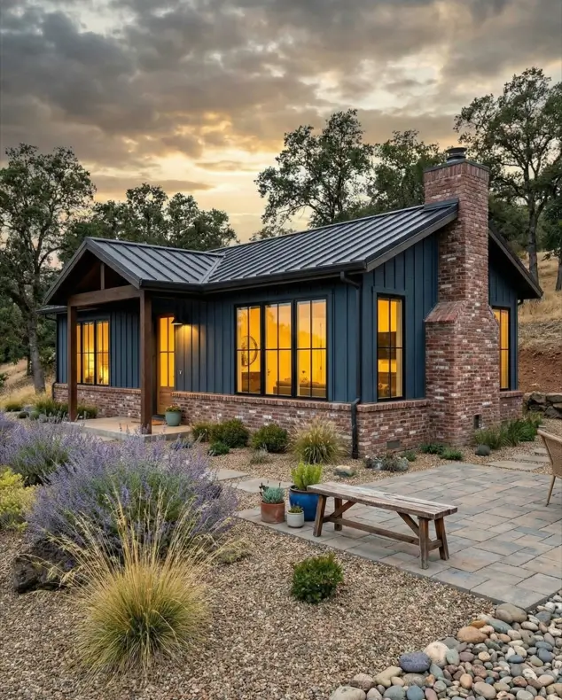 26 Small Ranch-Style House Ideas for Timeless Modern Living 14 Blue vertical siding and rustic red brick foundation on a small Ranch-style house with a prominent brick chimney.