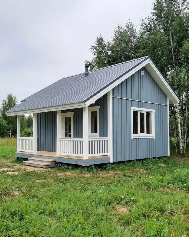 33 Small Scandinavian House Ideas That Prove Less Is More 20 Classic Scandi summer cottage with calming blue-grey siding and a white front porch.