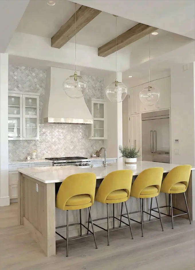34 Modern Tudor Kitchen Ideas: Old-World Charm, New Appeal 20 Bright kitchen featuring yellow velvet island stools, glass globe pendant lights, and a textured white tile backsplash.