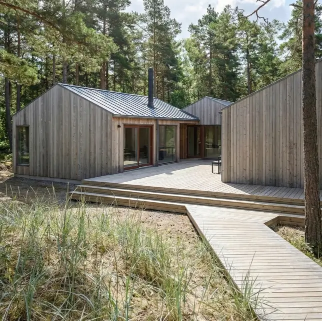 18 Scandinavian Cabin Design Ideas for Warm, Minimal Living 5 Weathered timber Scandinavian cabin design with a sprawling wooden deck and boardwalk integrated into a pine forest.