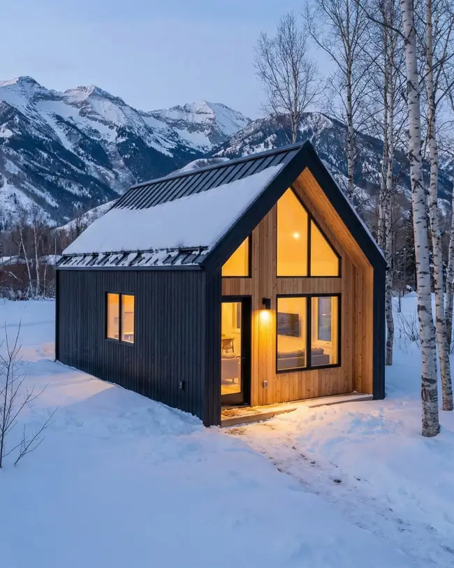 33 Small Scandinavian House Ideas That Prove Less Is More 29 Contrast gable retreat with a black protective shell and warm cedar gable end at twilight.