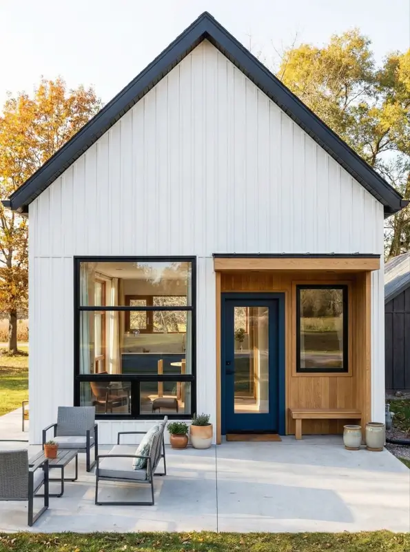33 Small Scandinavian House Ideas That Prove Less Is More 6 Small modern Scandinavian house with minimalist white gable, black window frames, and a recessed wood entry box.