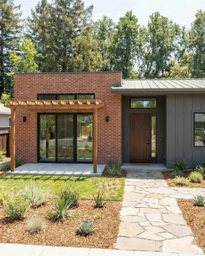 26 Small Ranch-Style House Ideas for Timeless Modern Living 7 Modern small Ranch house design combining red brick and dark grey siding with a wooden pergola for outdoor living.