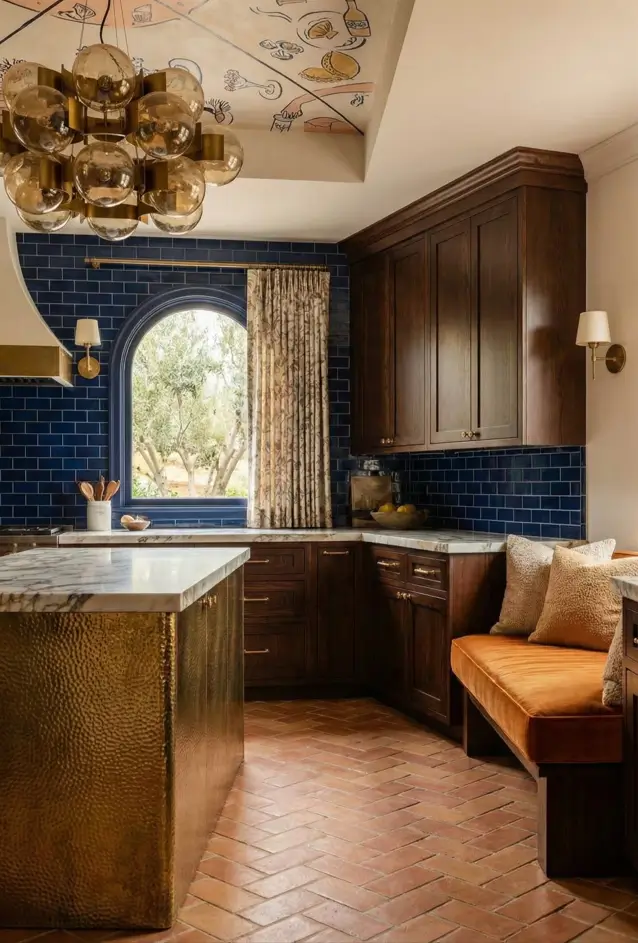 30 Mediterranean Kitchen Ideas for a Warm, Coastal Escape 13 Mediterranean kitchen decor with hand-painted ceiling fresco, hammered gold island, dark wood cabinets, and navy blue subway tiles.