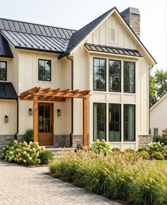 26 House with Board and Batten Siding Ideas for a Timeless Exterior 15 White house with board and batten siding featuring a wooden pergola over the entrance.