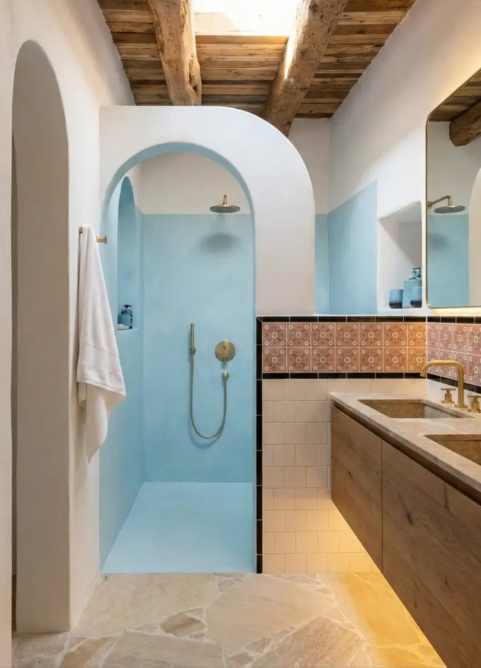30 Mediterranean Bathroom Ideas for a Modern Coastal Escape 18 Sky-Lit Blue Shower Mediterranean style bathroom featuring a sky-blue plaster shower arch illuminated by a natural skylight.