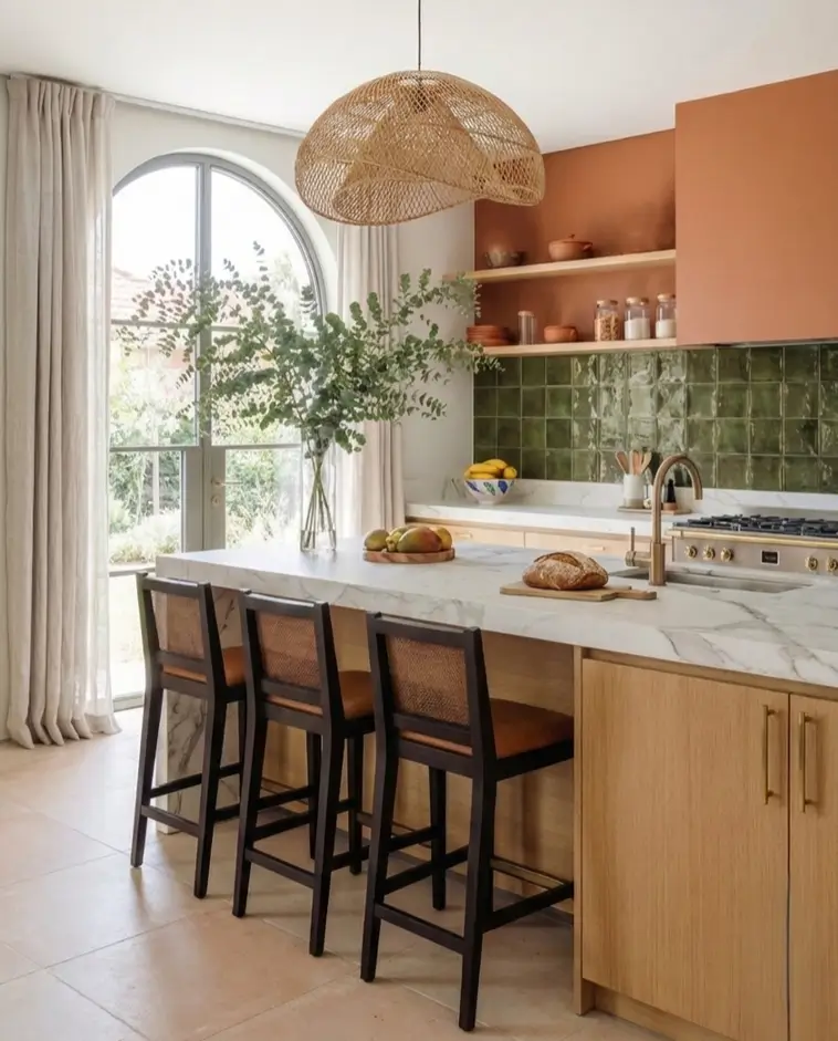 27 Modern Mediterranean Interior Design Ideas That Feel Effortlessly Chic 20 Contemporary Mediterranean home decor kitchen pairing a burnt orange vent hood with a glossy olive green tile backsplash.