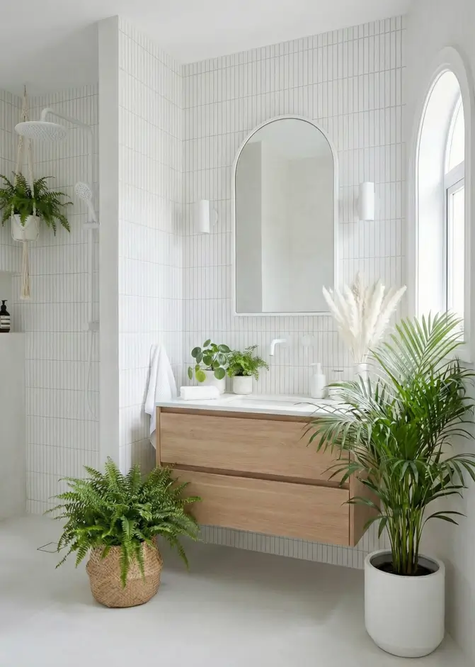 30 Mediterranean Bathroom Ideas for a Modern Coastal Escape 5 Crisp Botanical Retreat Bright modern Mediterranean bathroom with vertical white subway tiles, a floating oak vanity, and lush potted greenery.