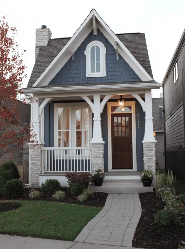 35 Small Craftsman House Ideas for Timeless Charm & Modern Living 33 Small Craftsman house featuring deep blue shakes on a narrow facade.