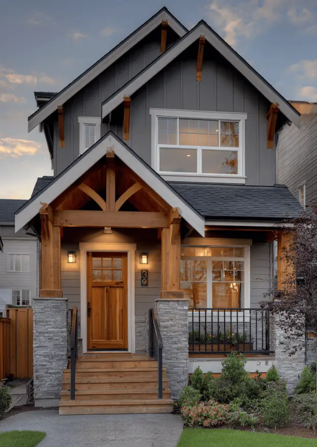 35 Small Craftsman House Ideas for Timeless Charm & Modern Living 36 Small Craftsman house with grey siding and timber frame stone details.