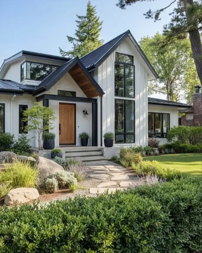 White Farmhouse With Black Trim: 34 Ideas for a Timeless Exterior 9 Natural wood front door and stone walkway warming up a white farmhouse with black trim.
