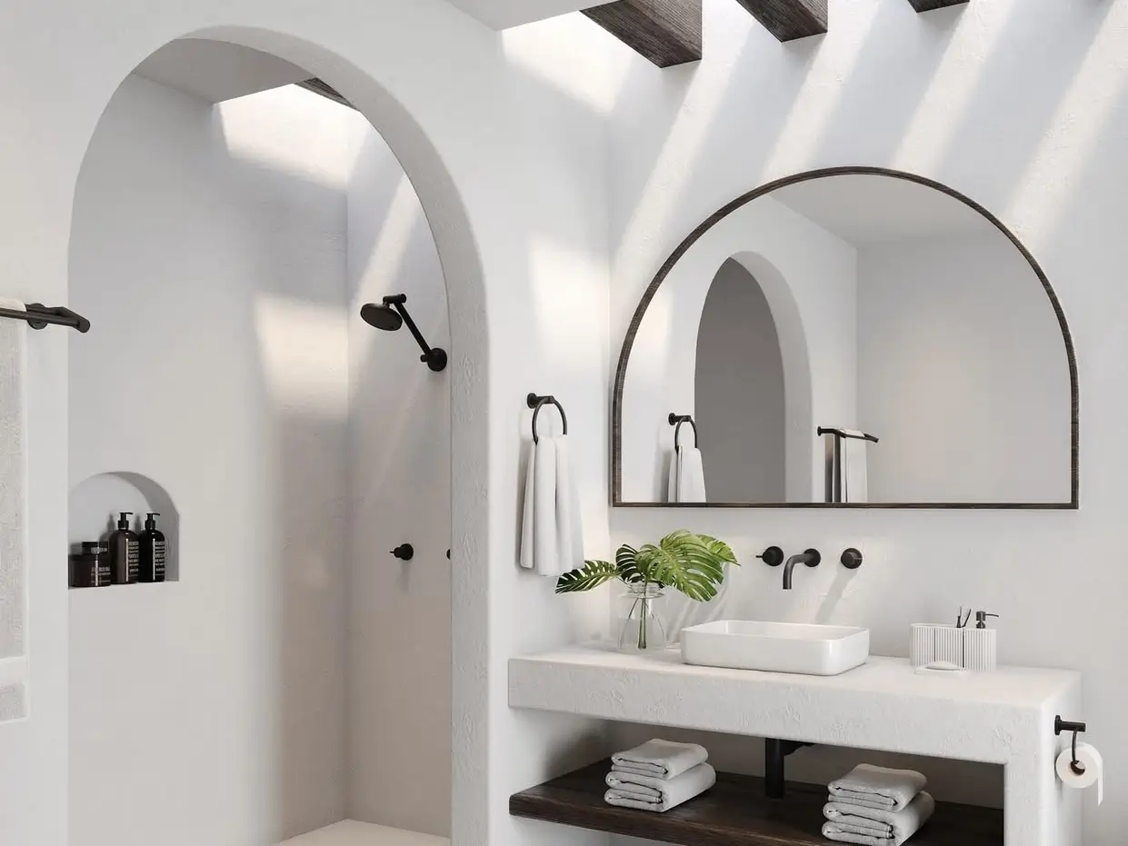 Sun-drenched modern Mediterranean bathroom featuring tactile travertine walls, arched architecture, and warm natural light, illustrating the perfect coastal escape.