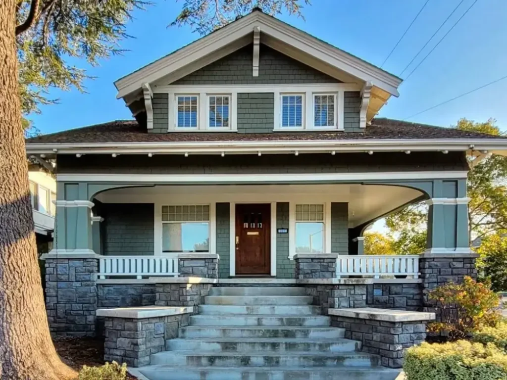 35 Small Craftsman House Ideas for Timeless Charm & Modern Living 66 A welcoming small Craftsman house exterior featuring tapered columns, deep eaves, and a cozy front porch, illustrating timeless architectural charm.