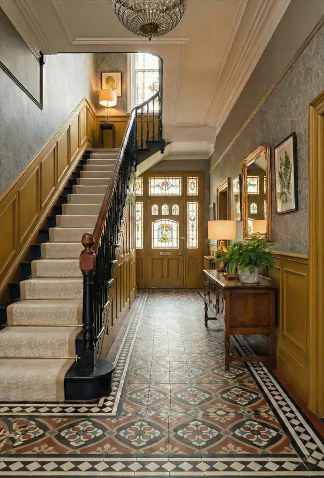 30 Modern Victorian Home Interior Ideas That Feel Timeless 3 Geometric Victorian floor tiles anchor this entryway, complemented by mustard wainscoting and stained glass door details.