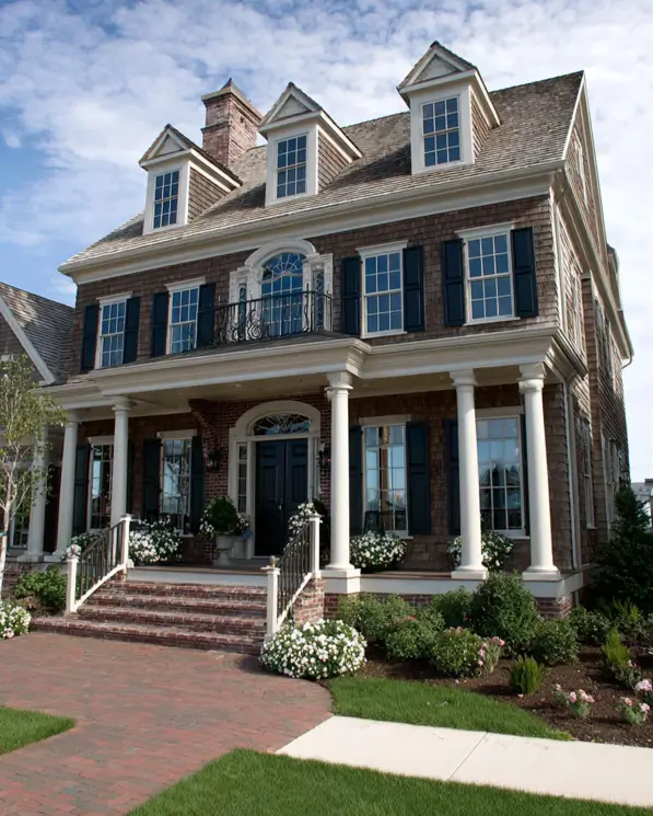45 Colonial House Design Ideas for a Timeless Exterior 43 Hamptons-style three-story shingled Colonial with natural cedar shakes, wraparound porch, white columns, three gabled dormers, and Juliet balcony