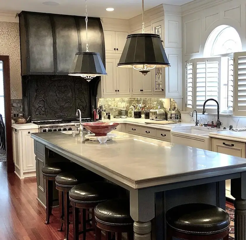 Colonial Style Kitchen: 26 Timeless Ideas, Cabinets & Designs 3 Colonial style kitchen with a hand-worked black metal range hood, cream raised-panel cabinets, and a marble island