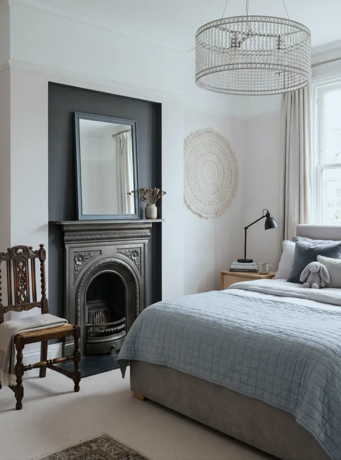 Victorian Style Bedroom: 30 Ideas for Romance Without the Heaviness 17 Modern Victorian style bedroom with original cast-iron fireplace, dark painted recess, antique chair, and grey linen bedding