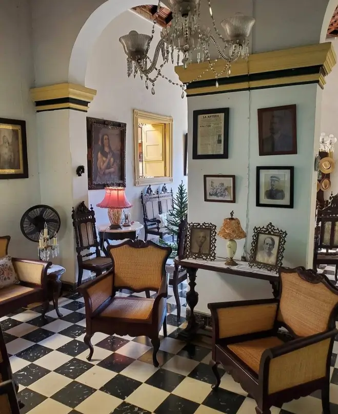 Colonial Interior Design Style: American vs. British (33 Real-Home Ideas) 4 Authentic Spanish Colonial parlor with carved mahogany cane chairs, marble checkerboard floor, archways, and ancestral portraits